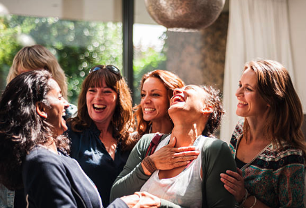 Group of Women in a Circle celebrating friendship over 50, group of joyful midlife women in a circle, representing connection and empowerment.